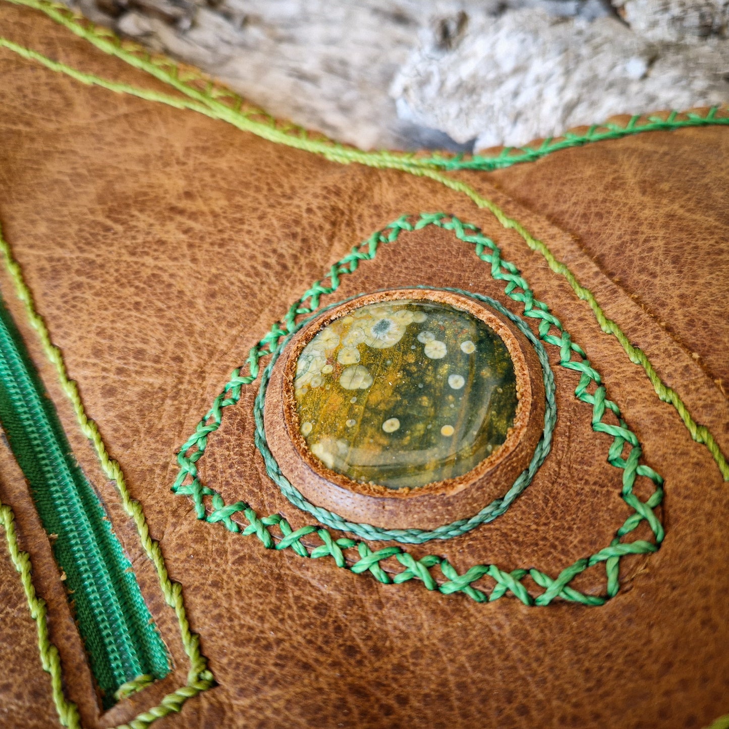 Brown leather bag with green string